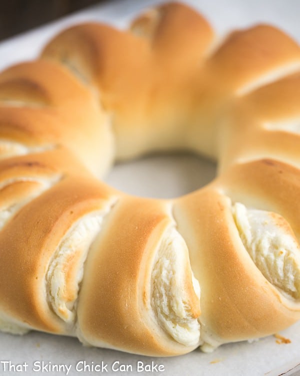Close up view of Cream Cheese Tea Roll on a parchment lined baking sheet.