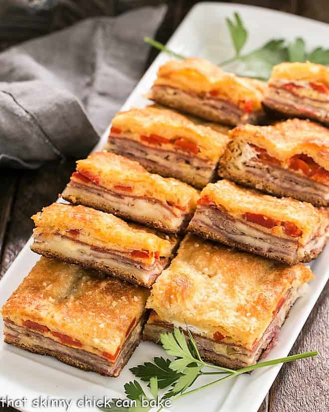 Antipasto Squares lined up on a rectangular platter.