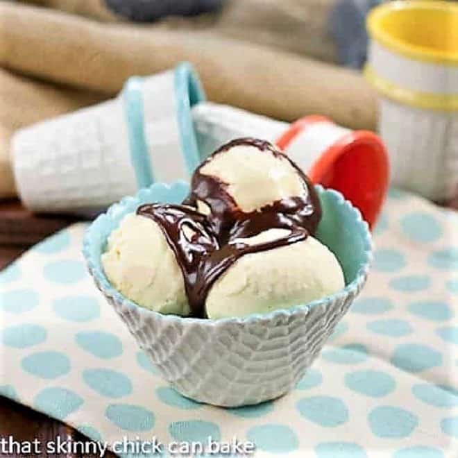 Hot fudge sauce - Rich and decadent hot fudge you can make at home! Hot fudge sauce over ice cream in a turquoise and white bowl