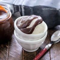 Hot Fudge Sauce over a scoop of vanilla ice cream in stackeed white bowls