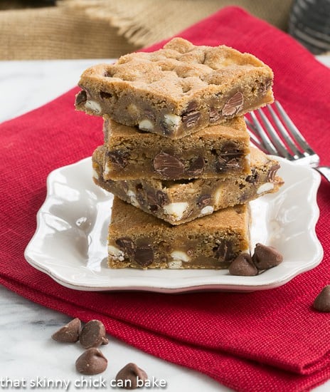 Chippy Bars AKA - Chocolate Chip Cookie Bars - Kid friendly, super easy chocolate chip cookie dessert! Chippy Bars AKA - Chocolate Chip Cookie Bars stacked on a square white plate with a fork