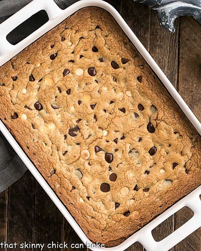 Overhead view of baked cookie bars in a white ceramic baking pan.