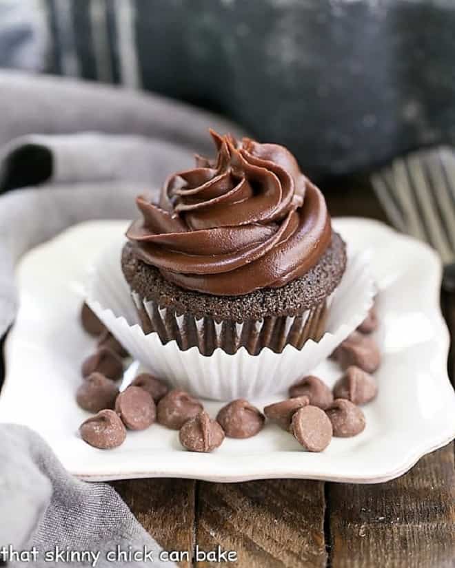 Ghirardelli Dark Chocolate Cupcakes on a square white plate with chocolate chips.