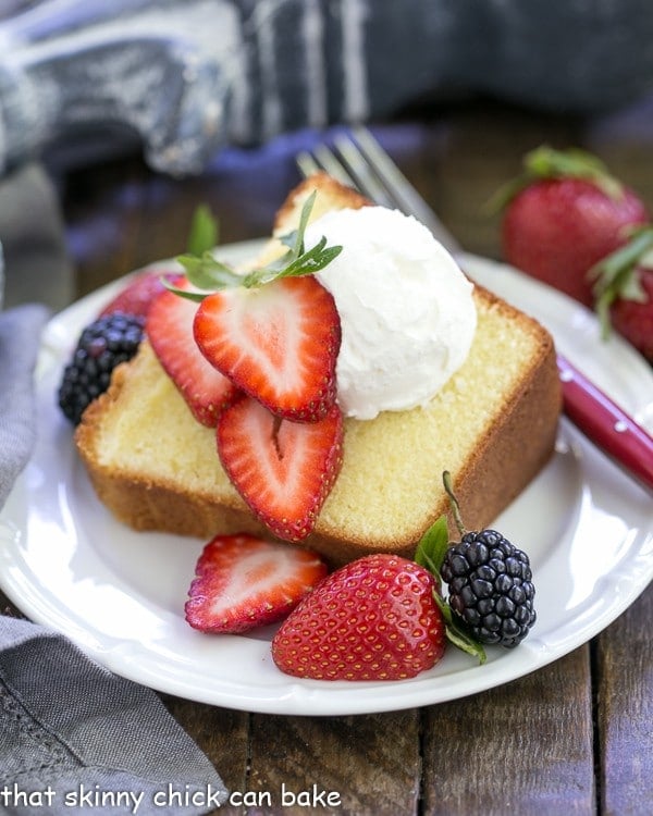 The Best Pound Cake slice topped with berries and cream.