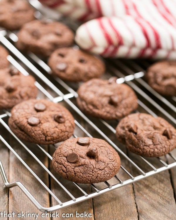 Triple Chocolate Cookies on a cooling rack with a red and white striped oven mitt