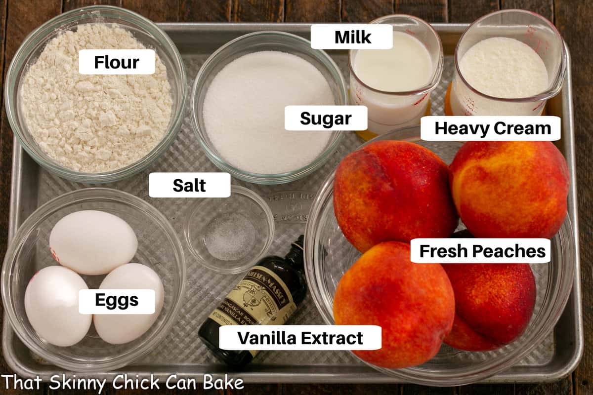 Peach Clafoutis ingredients on a metal sheet pan with labels.