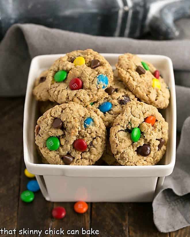 Classic Monster Cookies piled in a ceramic basket