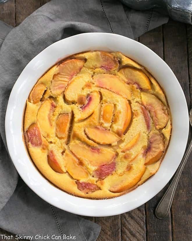Fresh Peach Clafoutis in a white pie plate from above