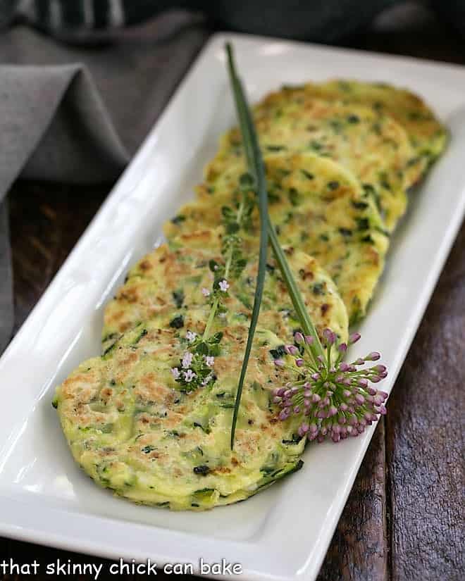 zucchini fritters on a white rectangle tray