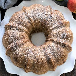 Overhead view of apple bundt cake on a white plate