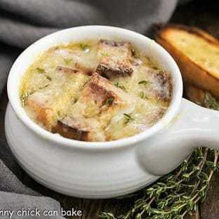 Classic French Onion Soup - A rich onion laden broth flavored with herbs, white wine and cognac and topped with cheesy toast!