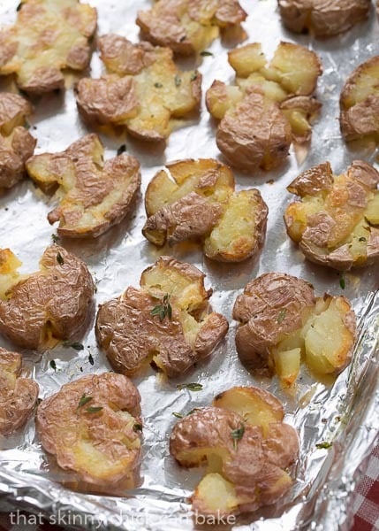 Crsipy Smashed Potatoes on a foil lined sheet pan.