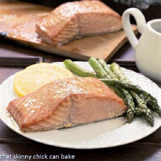 Grilled Cedar Plank Salmon on a white plate with asparagus