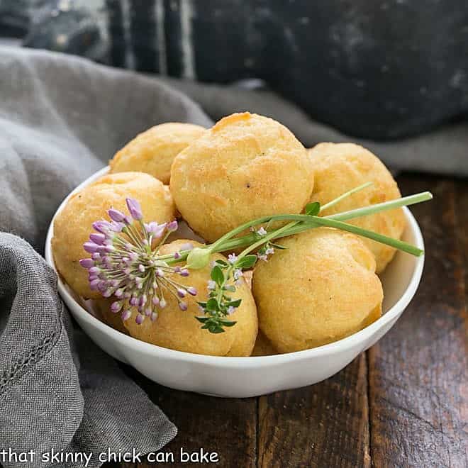 Bowl of cheese puff with chive and thyme garnishes