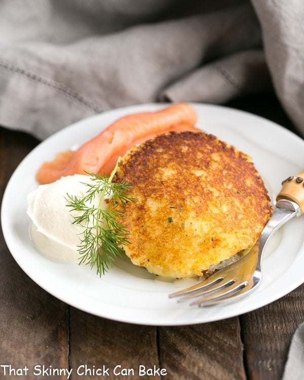 Gruyere Potato Cakes with smoked salmon on a small white plate