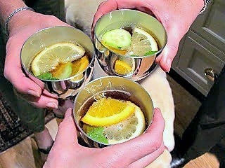 Toasting with Pimm's Cup in pewter cups