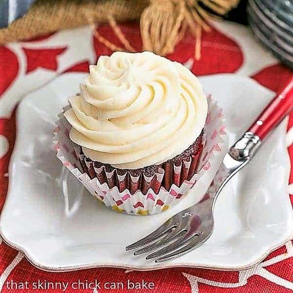 Red Velvet Cupcakes on a square white plate with a red handled fork.