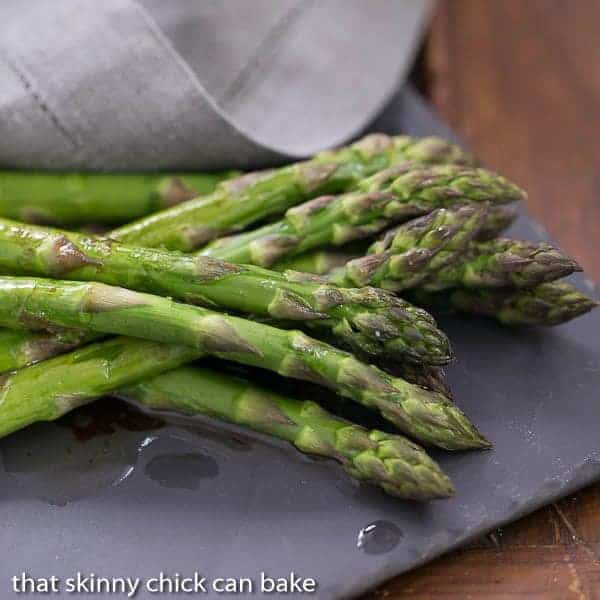 Oven Roasted Asparagus with Balsamic Brown Butter on a slate serving platter.