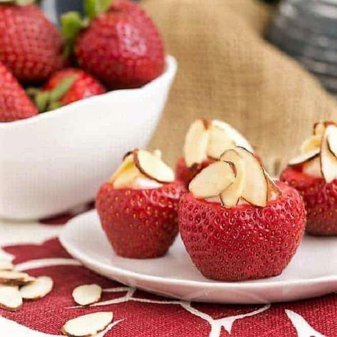 Cheesecake Stuffed Strawberries on a small white plate.