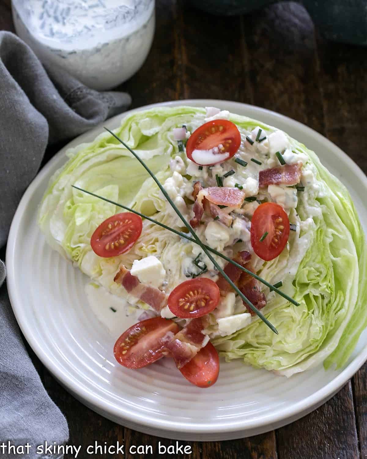 Overhead view of wedge salad on a white plate.