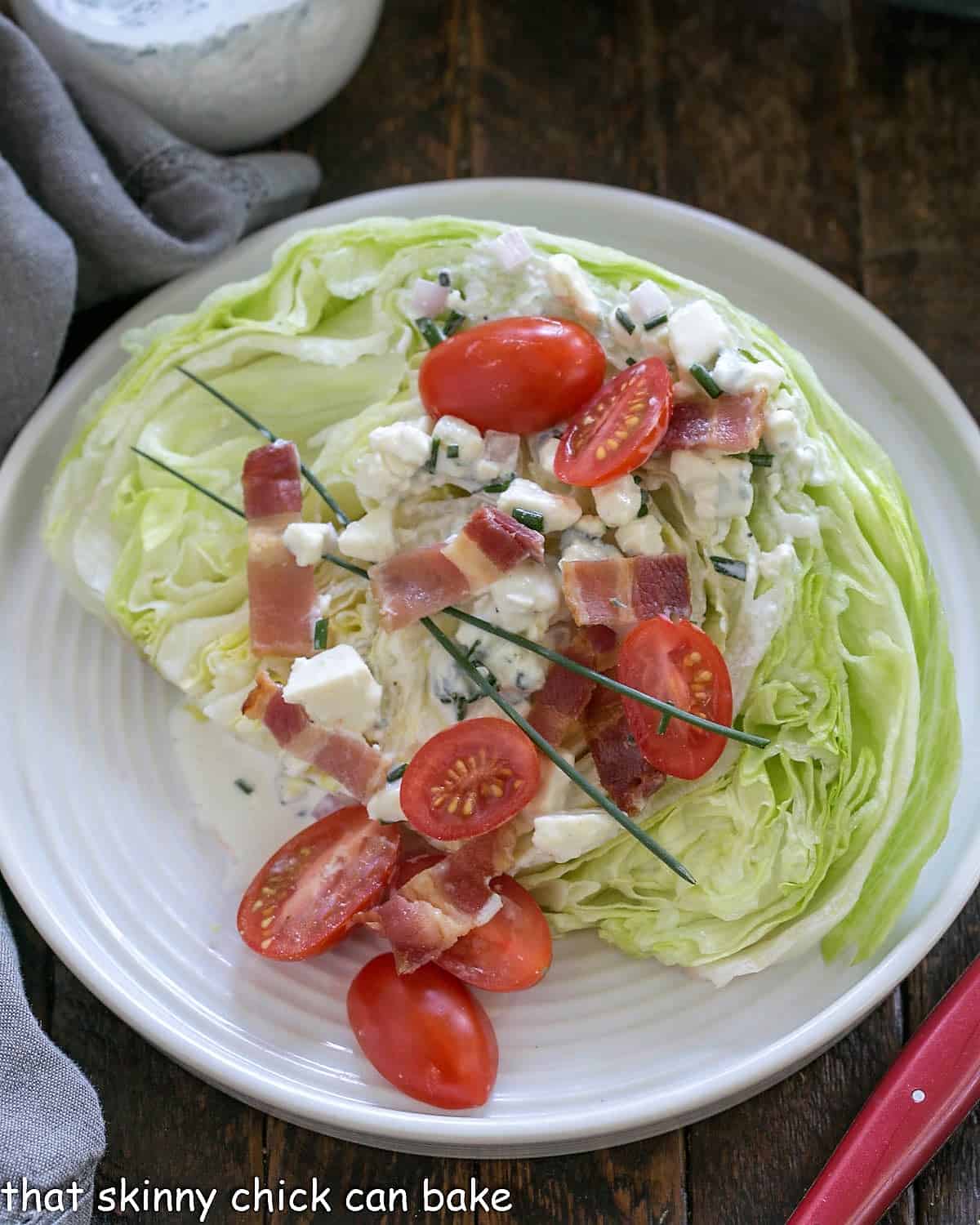 Overhead of Iceberg lettuce wedge salad with homemade blue cheese salad dressing.