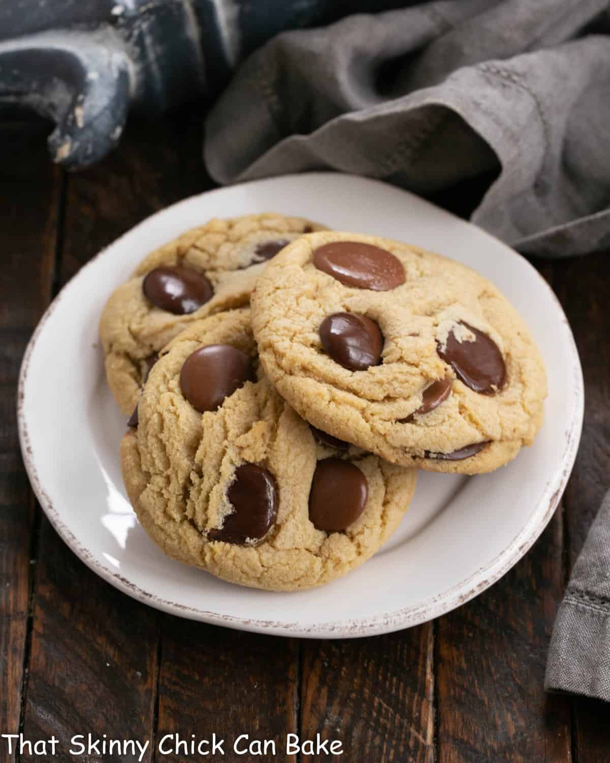 Overhead view of 3 cookies on a white dessert plate.