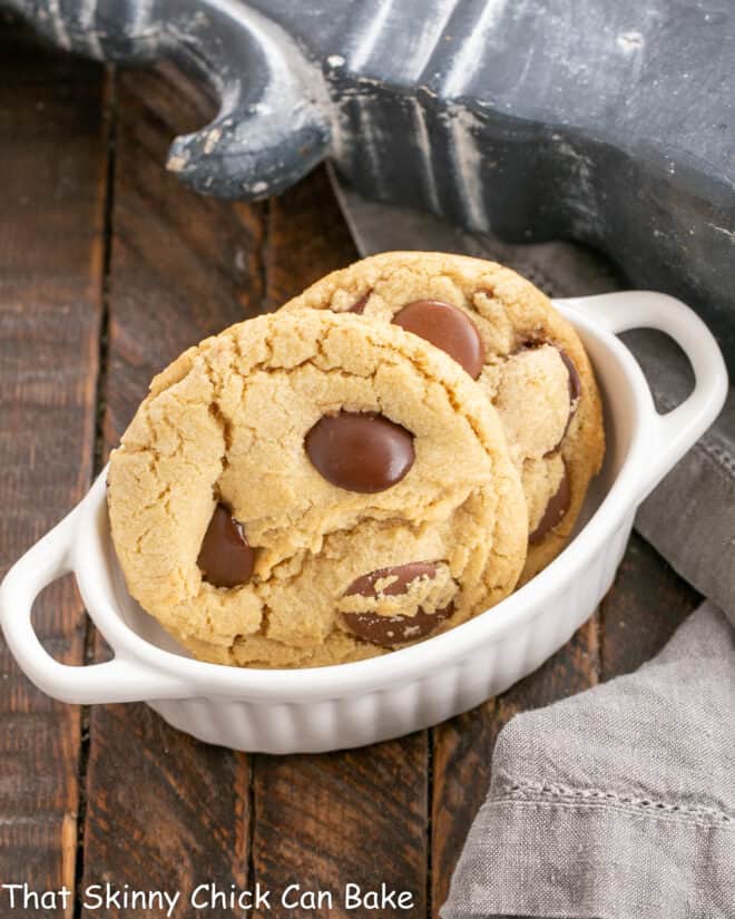 2 chocolate chunk cookies in a  white fluted terrine.