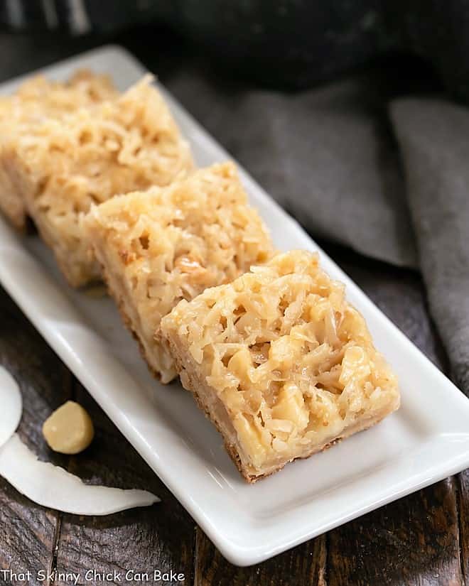 Coconut Macadamia Nut Bars on a white ceramic tray.