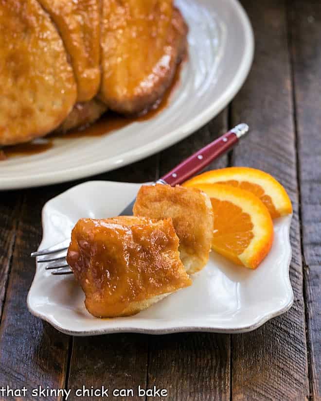Easy Monkey Bread pieces on a small white plate with orange slices.