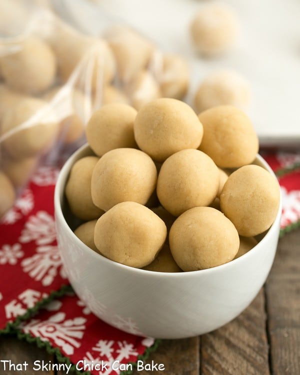 A bowl full of cookie dough balls ready for freezing