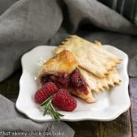 Slice of baked brie on a square white plate with crackers