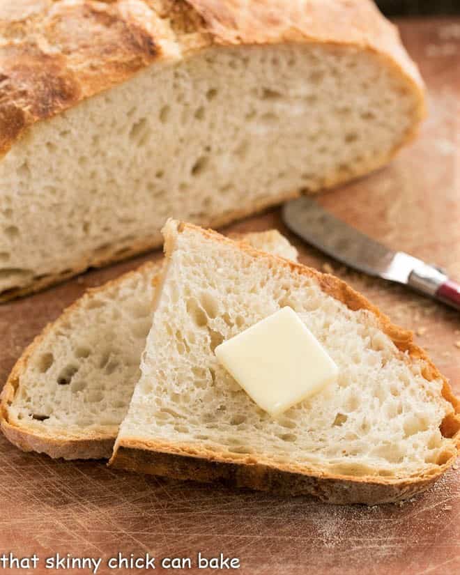 No-Knead bread slices on a cutting board.