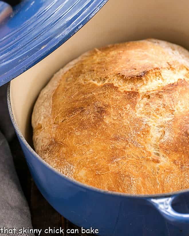 Easy Bread Recipe - a unique, bread recipe that doesn't require kneading and results in a delicious, rustic loaf with an open crumb No-Knead Bread in a blue Dutch oven