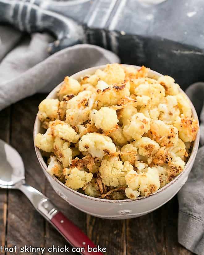 Overhead view of Roasted Cauliflower with Parmesan and Bread Crumbs in a round white bowl. 