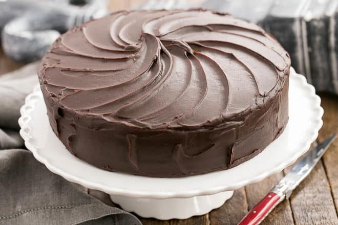 Vertical image of Triple Layer Cocoa Cake on a white cake stand