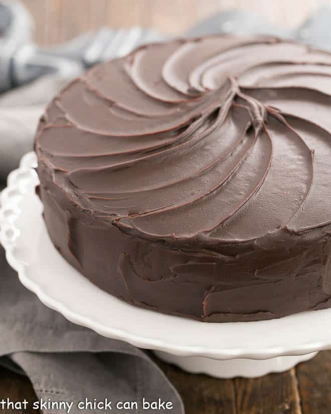 Triple Layer Cocoa Cake on a white cake ceramic stand.