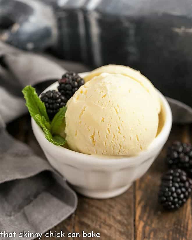 White Chocolate Ice Cream in a white bowl with blackberries and mint.