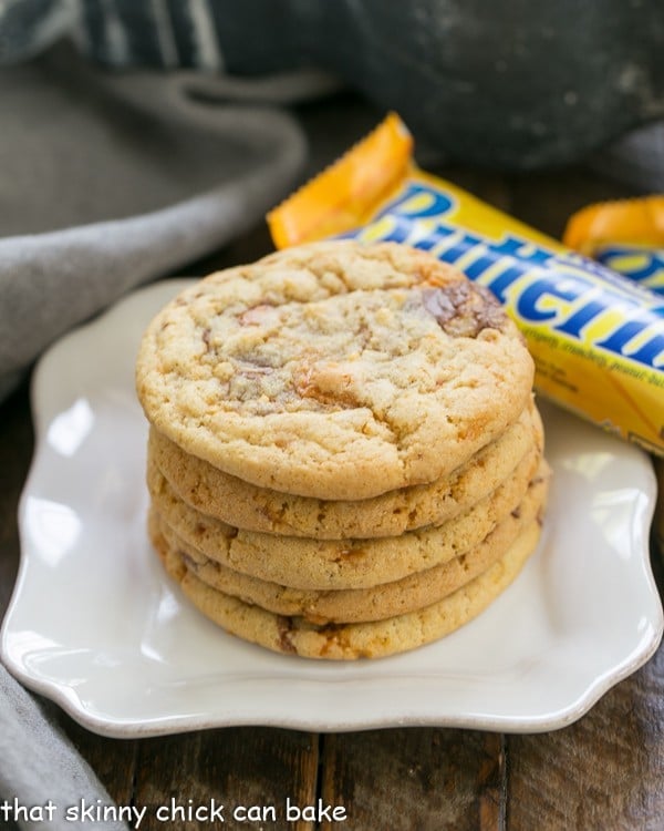 Chewy Butterfinger Cookies stacked on a white plate.