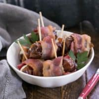 Bacon Wrapped Dates in a small white bowl