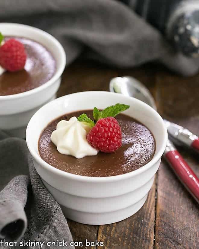 Chocolate Pots de Crème with White Chocolate Whipped Cream in white ramekins