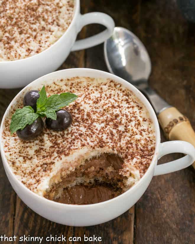 A cup of chocolate tiramisu with a spoonful removed