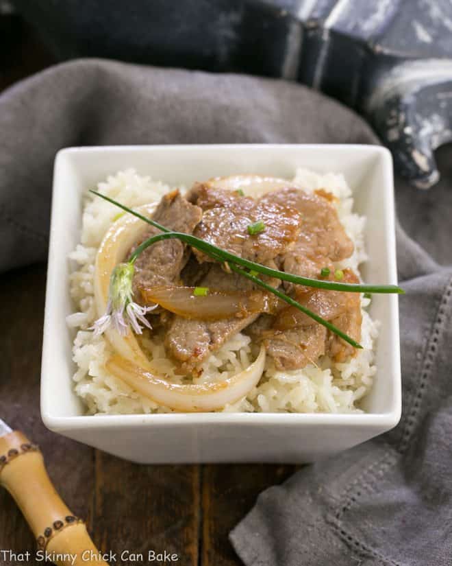 Korean Stir Fry in a square white bowl over rice.