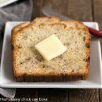Buttermilk Banana Bread on a square white plate with a red handled knife