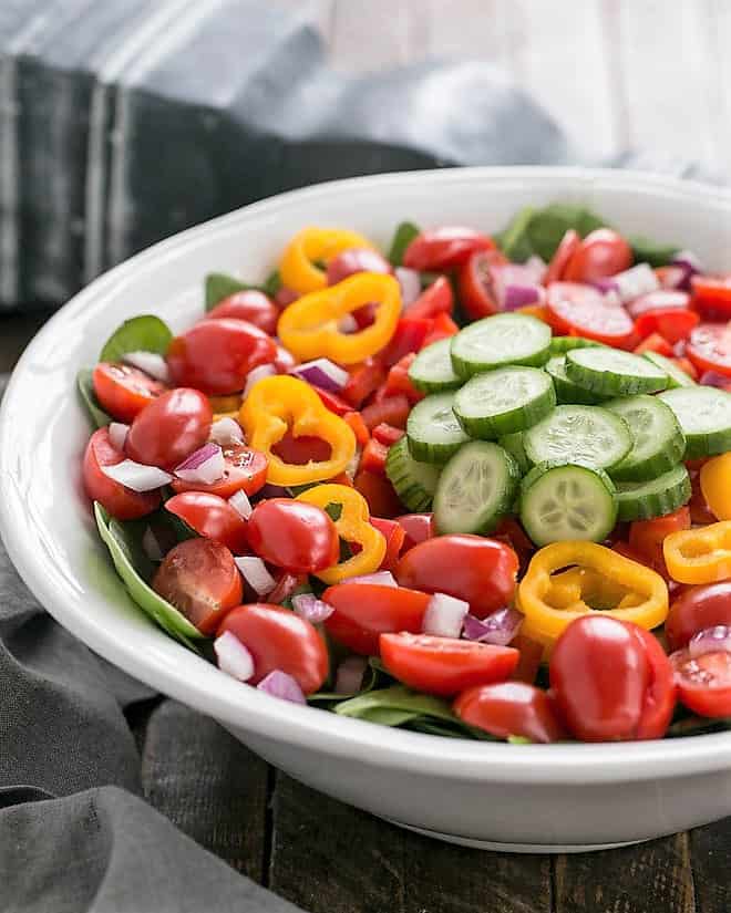 Undressed Gazpacho Spinach Salad in a white ceramic serving bowl.