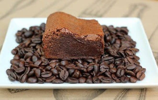 Kahlua Brownies on a white plate covered with coffee beans