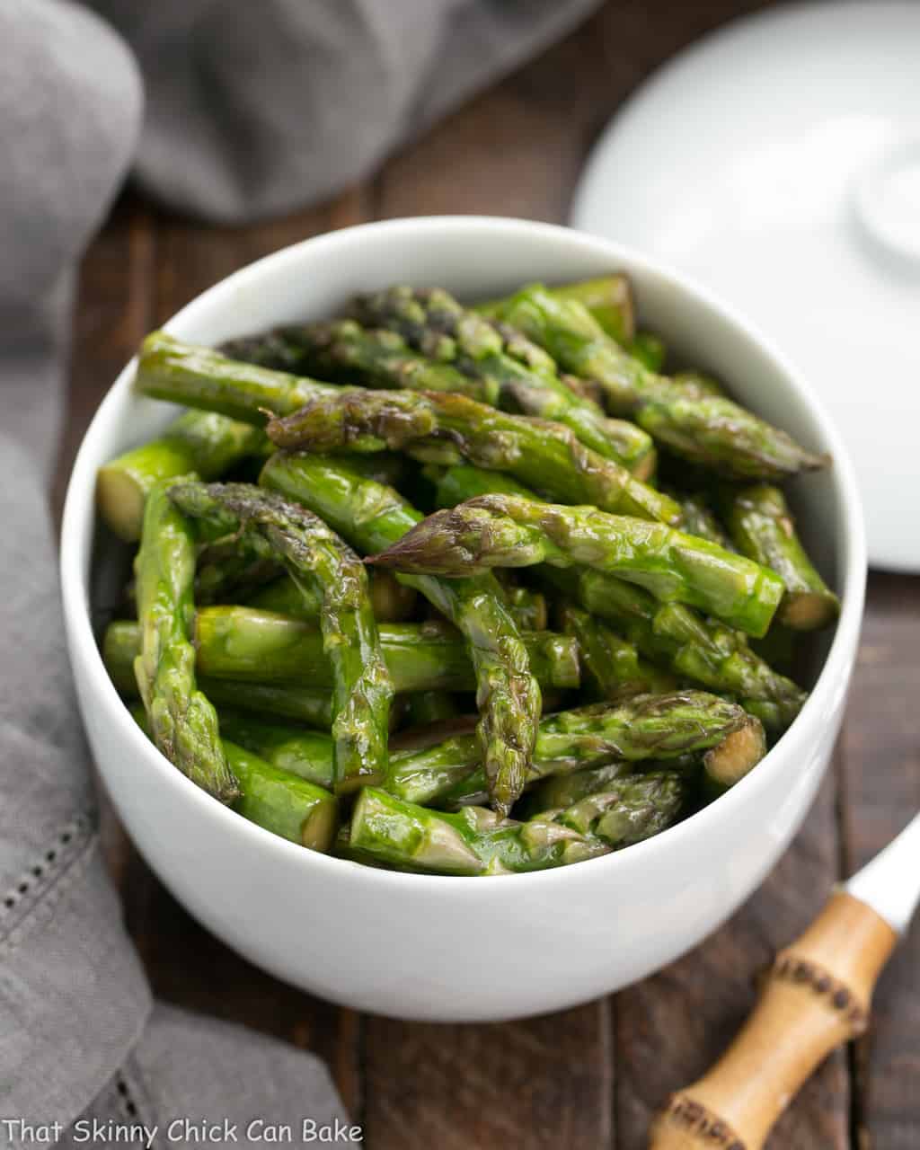 A white bowl of Asian Stir Fried asparagus