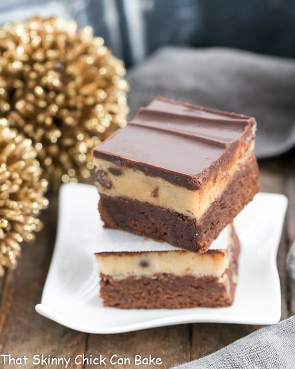 Chocolate Chip Cookie Dough Brownies stacked on a small, rippled white plate.