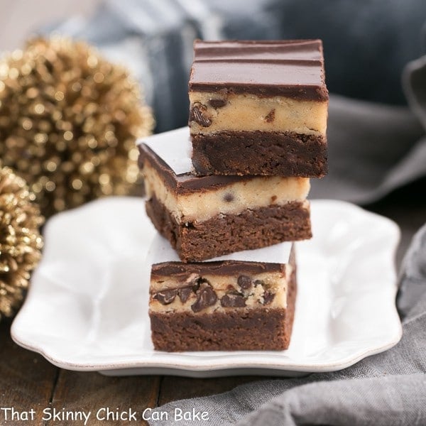 Chocolate Chip Cookie Dough Brownies stacked on a white ceramic plate.