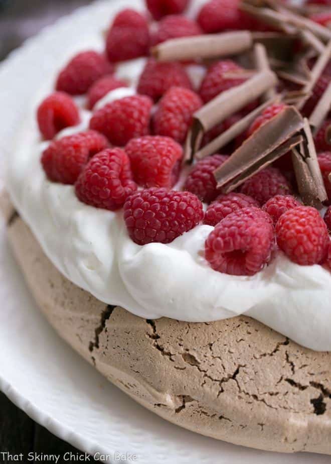 Close view of Chocolate Raspberry Pavlova on a white serving plate.