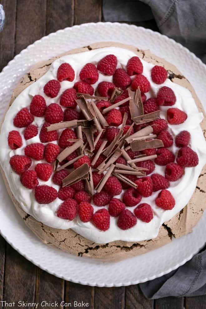 Overhead view of Chocolate Raspberry Pavlova on a white ceramic plate.